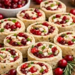 Keto Savory Christmas Cranberry Roll Ups arranged on a festive holiday platter